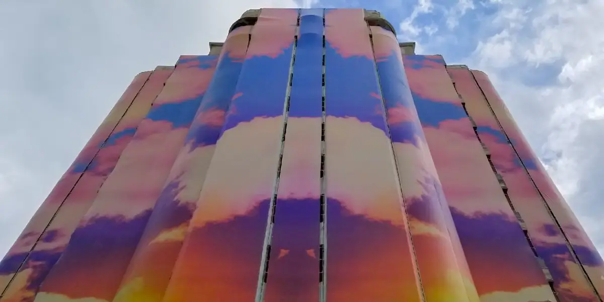 Building wrap depicting a cloudy sunset
