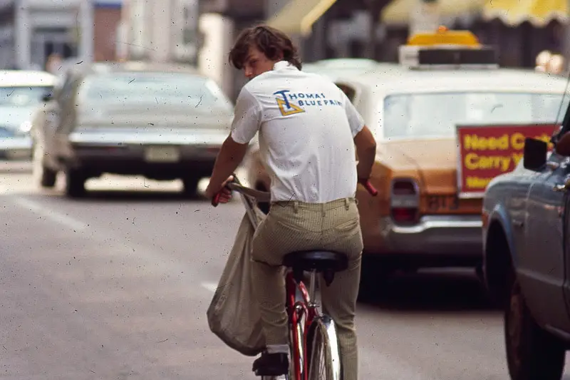Old photo of a Thomas Blueprint delivery person on a bicycle