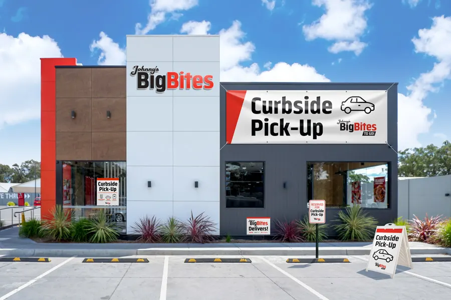 A fast casual restaurant with outdoor graphics advertising curbside pickup