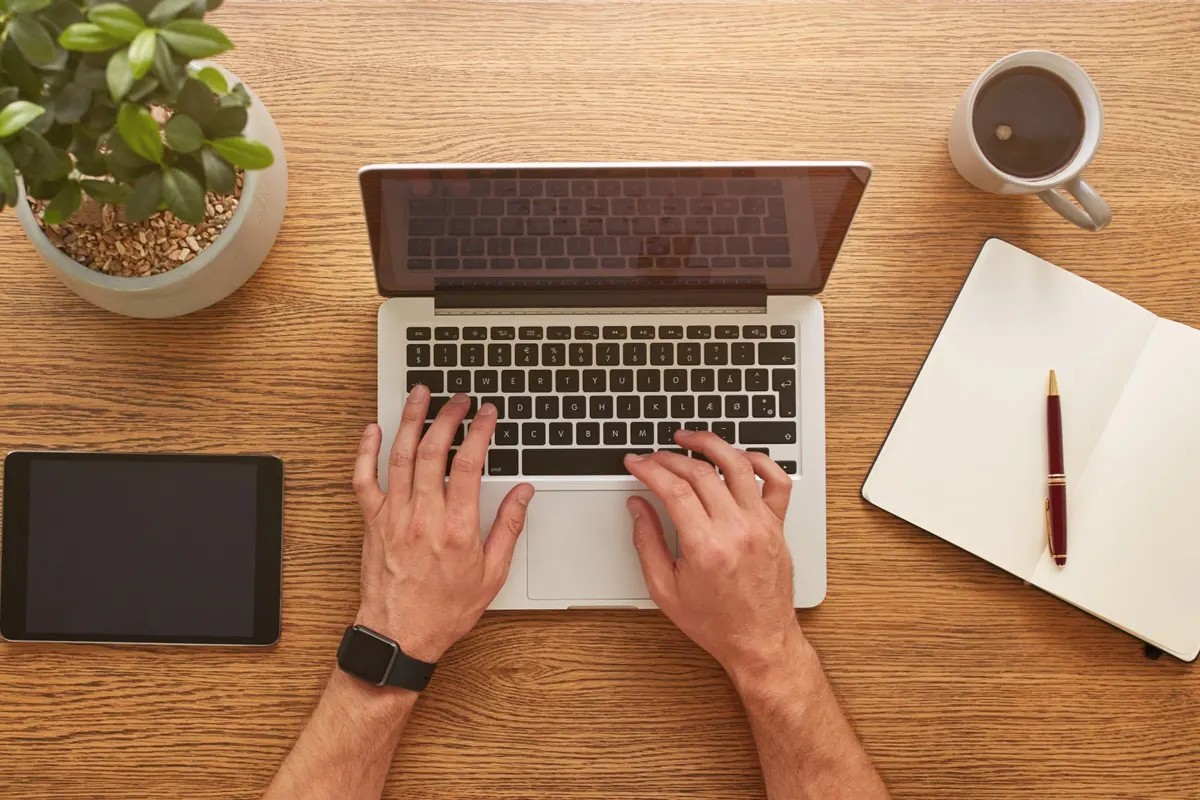 A person typing on a laptop computer